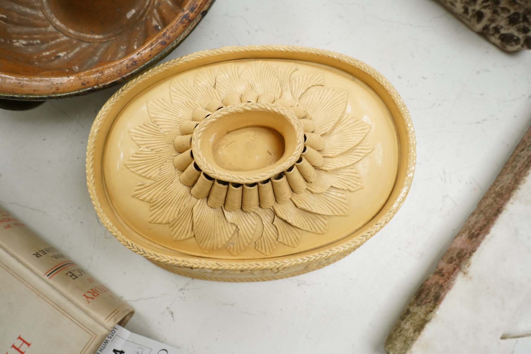 A 19th century oval caneware game/pie dish and cover, 24cm wide with an antique cake mould, (2)